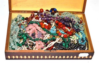 Lot 395 - A box containing assorted beads, mixed gemstone necklaces and cultured and simulated pearl...