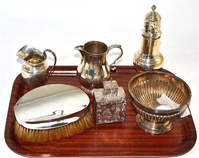 Lot 398 - A collection of silver including a hairbrush, a sugar bowl, a Neo-Classical style cream jug, a...