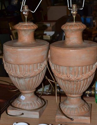 Lot 402 - Pair of terracotta effect table lamps decorated with swags