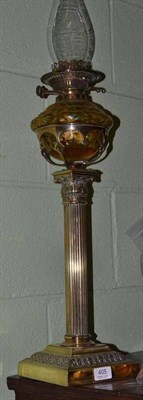 Lot 405 - A Victorian brass oil lamp with amber coloured glass reservoir