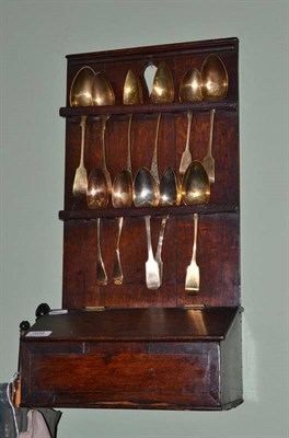 Lot 408 - An 18th century oak spoon rack and a quantity of assorted spoons