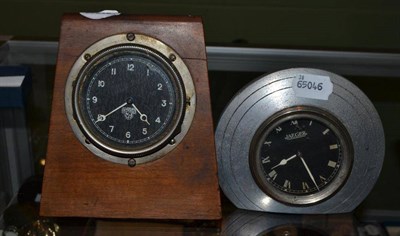 Lot 435 - A Jaeger dashboard clock in an aluminium mount and a Smiths dashboard clock in a wooden frame