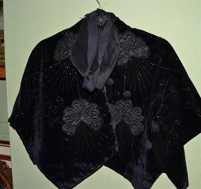 Lot 446 - Victorian black velvet cape embroidered with silk flowerheads and beads and a black cord hat...