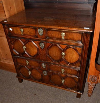 Lot 519 - An oak four drawer chest with geometric moulding