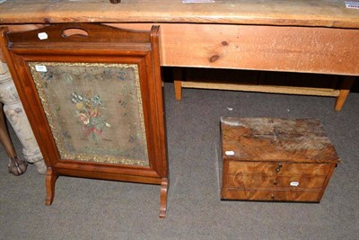 Lot 524 - A fire screen containing a needlework panel dated 1809 and a three drawer mahogany small chest