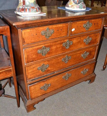 Lot 546 - Oak and crossbanded straight fronted five drawer chest