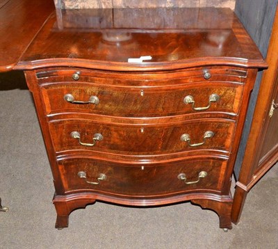 Lot 549 - Reproduction mahogany three drawer chest with brushing slide