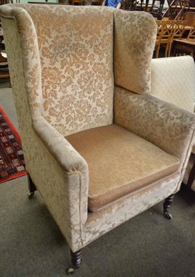 Lot 571 - George IV wingback chair upholstered in yellow and floral velvet raised on turned forelegs