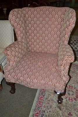 Lot 573 - Early 20th century wing back chair on claw and ball feet