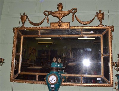 Lot 610 - An Adams style overmantel mirror decorated with urns