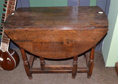 Lot 614 - An 18th century oak gateleg table