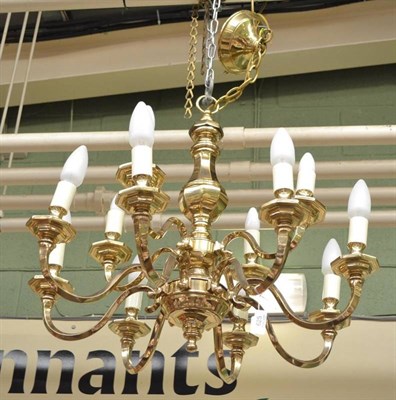 Lot 625 - A brass fourteen branch chandelier