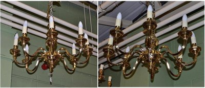 Lot 626 - A pair of brass eight branch chandeliers, en suite with lot 625