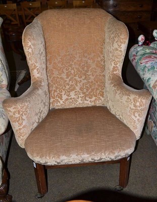 Lot 636 - Wing back armchair in George III style