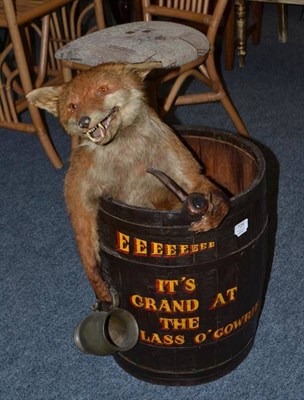 Lot 729 - An amusing pub stick stand, modelled with a taxidermy fox smoking a pipe and holding an empty...