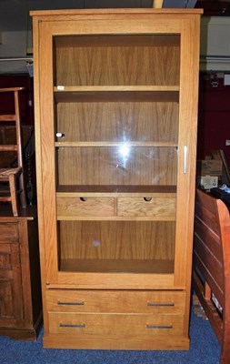 Lot 744 - Modern oak display cabinet with glazed door, internal shelves and two drawers below