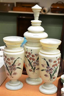 Lot 10 - A garniture of three Victorian opaque glass vases decorated with flowers (3)