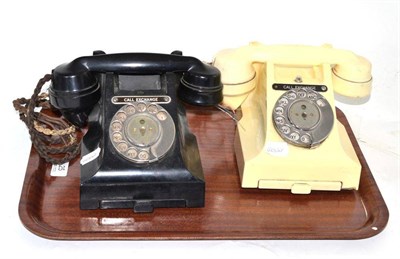 Lot 25 - Cream Bakelite vintage telephone and another in black (2)