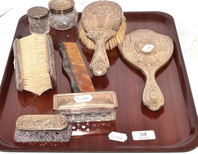 Lot 34 - An Art Nouveau silver backed four piece dressing table set, a similar hand mirror and four...