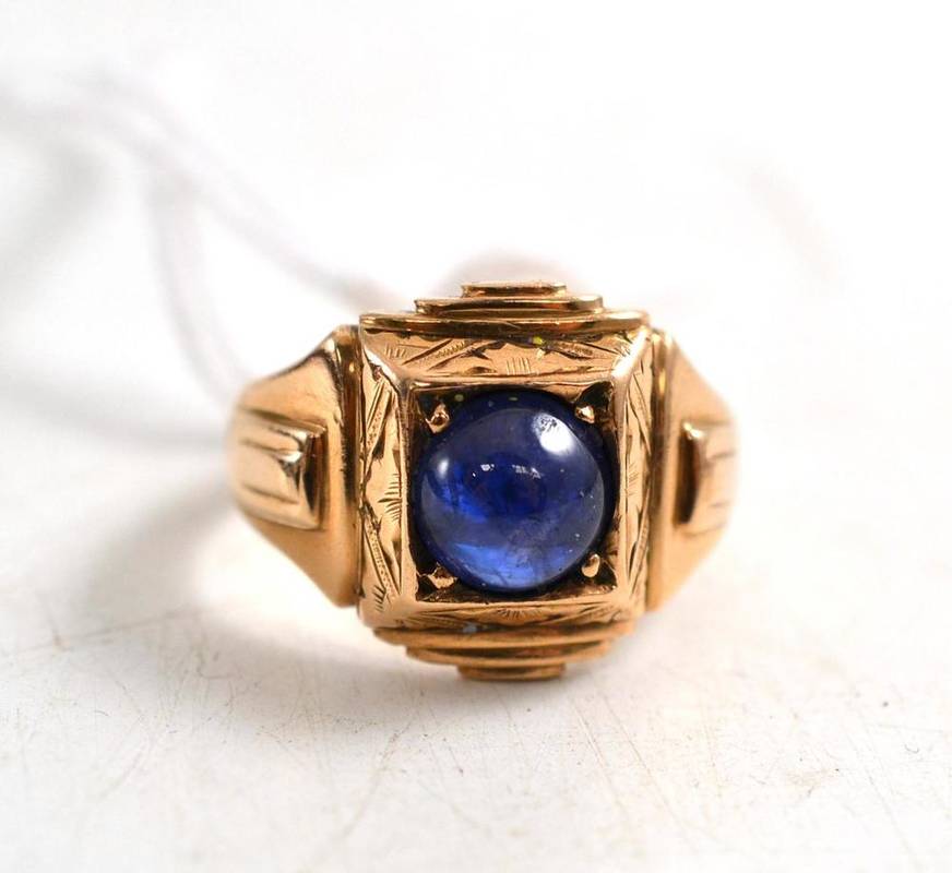 Lot 91 - Cabochon sapphire ring, in a squared ornate mount   Reputedly purchased at de Beers