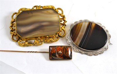 Lot 117 - Two large agate plaque brooches and an agate stickpin (3)