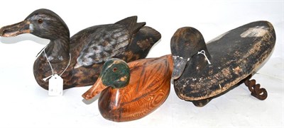 Lot 133 - An early 20th Century wood decoy duck, the underside stamped RMP; two modern wood decoy ducks (3)