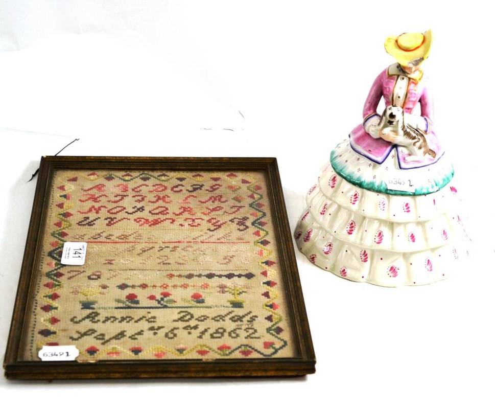 Lot 141 - A 19th century sampler, worked by Annie Dodds, 1862, and a Victorian earthenware model of a...