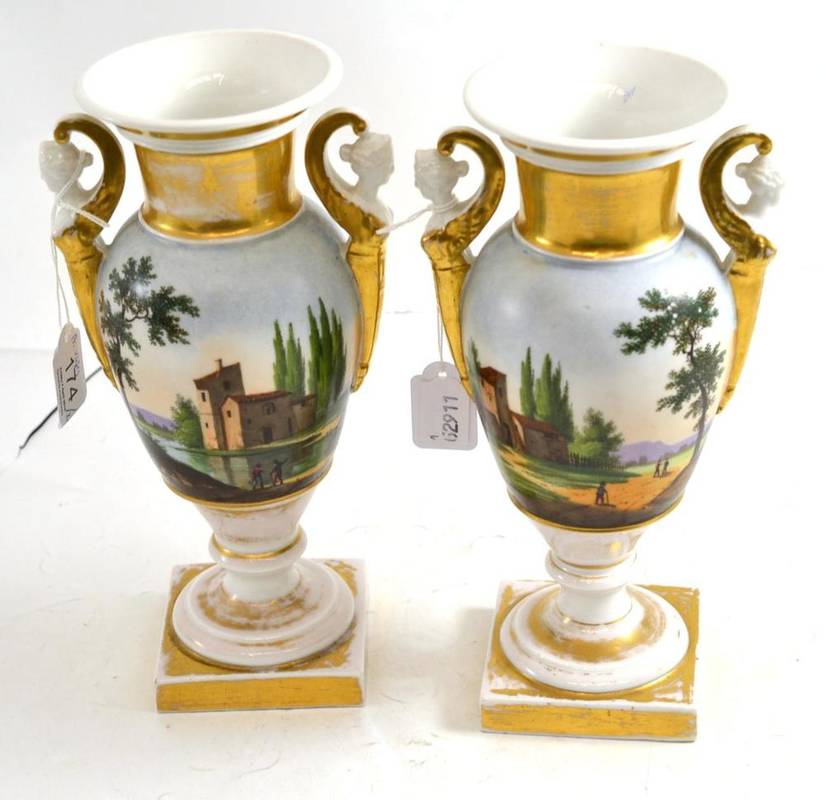 Lot 174 - A pair of Paris porcelain two handled vases painted with landscapes