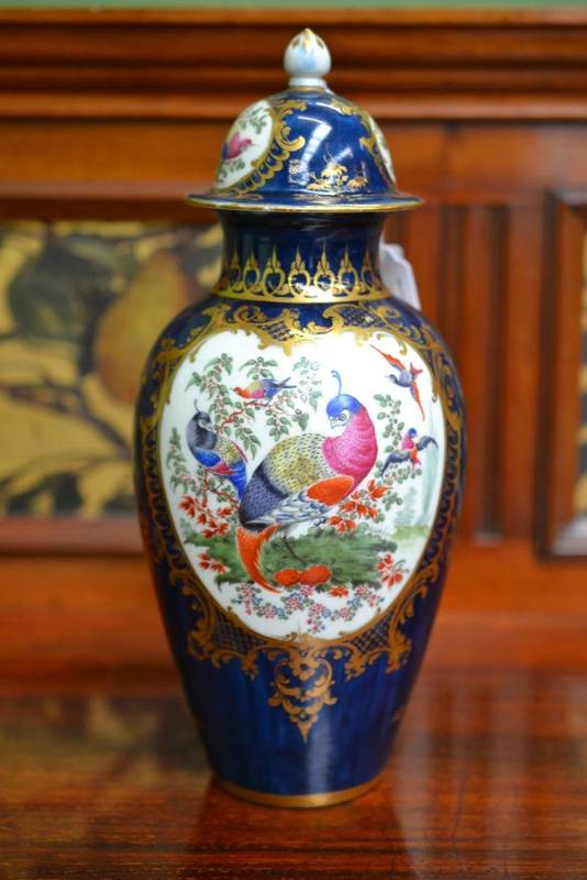 Lot 13 - A First Period Worcester Porcelain Baluster Vase and Cover, circa 1770, painted with exotic...