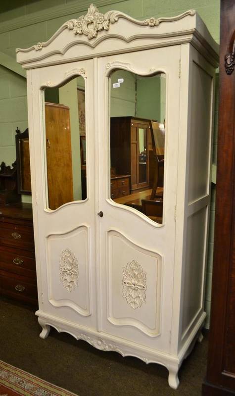 Lot 536 - A French style cream painted double wardrobe with mirrored drawers