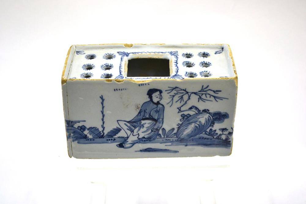Lot 29 - An English Delft Flower Brick, probably Bristol, circa 1750, of rectangular form with large central
