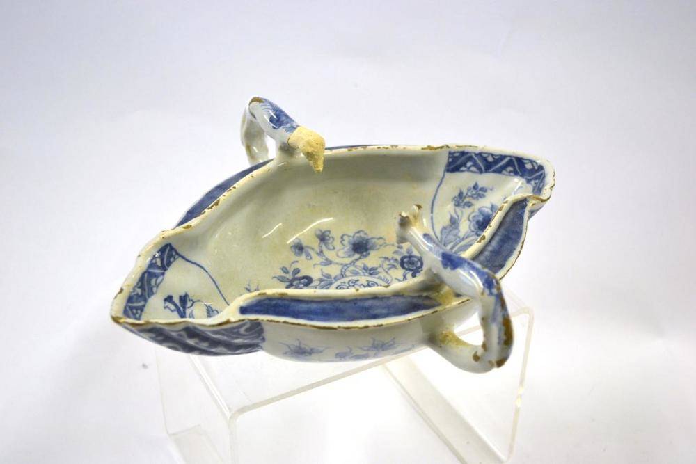 Lot 31 - An English Delft Twin-Handled Sauce Boat, possibly Liverpool, circa 1760, with hound handles...