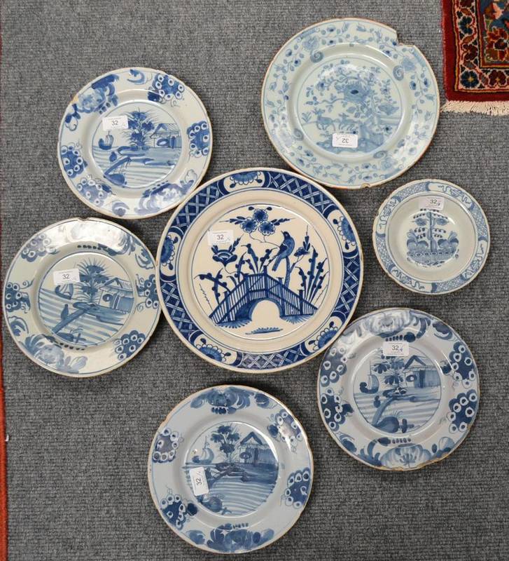 Lot 32 - A Set of Four English Delft Plates, probably London, circa 1760, painted in blue with a river scene