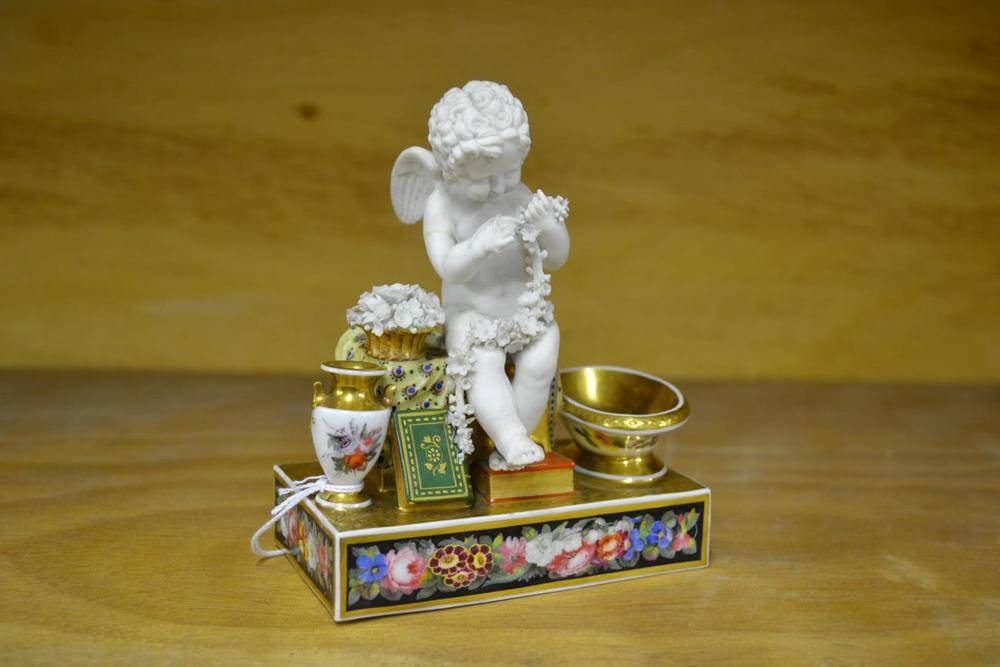 Lot 43 - A Chamberlains Worcester Porcelain Figural Inkstand, circa 1820, as a bisque putto holding a...