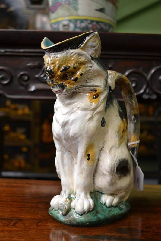 Lot 46 - A Minton Majolica Cat Milk Jug, circa 1875, the seated figure with tortoiseshell markings, a...