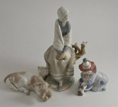 Lot 8 - Three Lladro figures comprising seated woman, melancholic clown with puppy and a seated cow