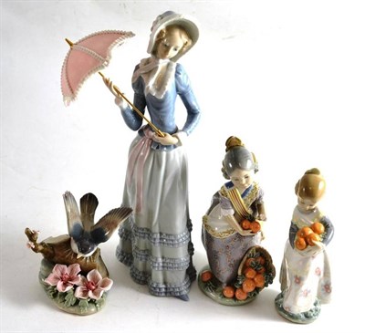 Lot 53 - Four Lladro figures comprising a figure of a young lady with a parasol, two children with...