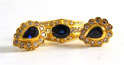 Lot 70 - A sapphire and diamond ring, stamped '750' and a pair of pear shaped sapphire and diamond...