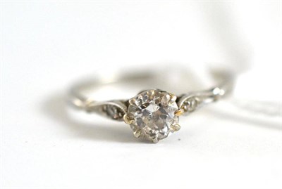 Lot 86 - A diamond solitaire ring with stone set shoulders