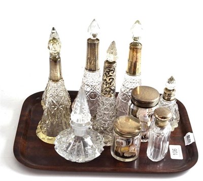 Lot 106 - Five tall cut glass scent bottles, all with silver collars and five other scent bottles/toilet jars