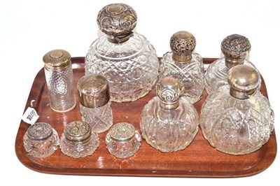 Lot 115 - A cut glass scent bottle with silver mounts, Birmingham 1903; four smaller examples; and five...