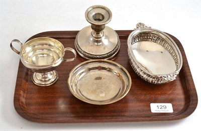 Lot 129 - A Victorian silver pedestal dish decorated with masks, a loaded silver candlestick, an oval pierced