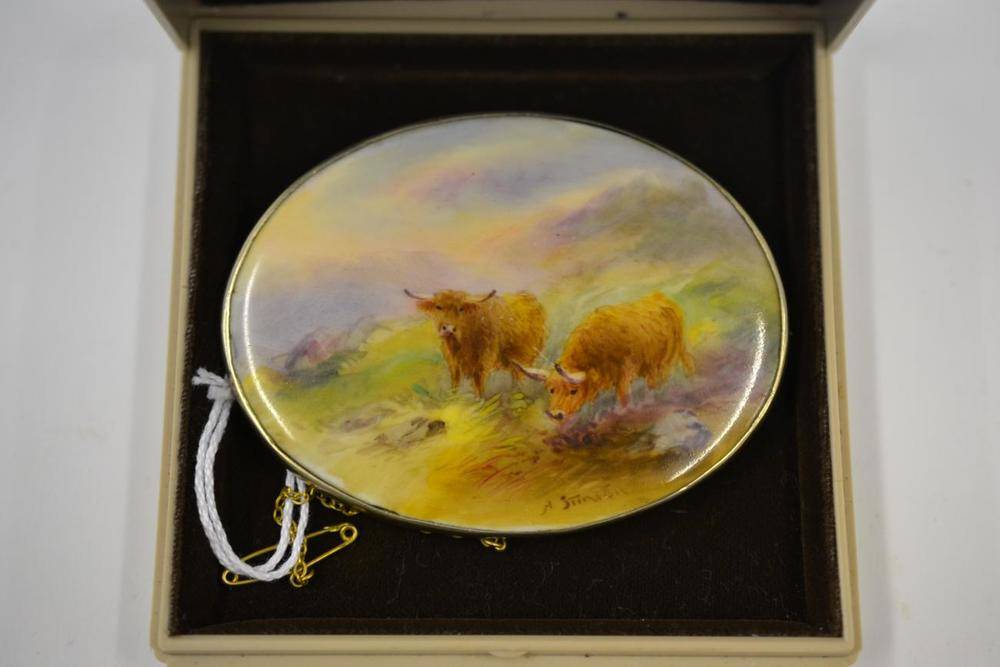 Lot 64 - A Royal Worcester Porcelain Oval Brooch, 1928, painted by Harry Stinton with highland cattle in...