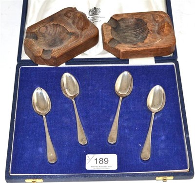 Lot 189 - Two Robert 'Mouseman' Thompson oak ashtrays and a cased set of four silver teaspoons (silver...