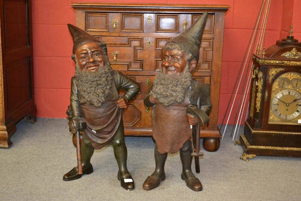 Lot 67 - A Pair of Polychrome Painted Standing Figures of Gnomes, each standing in aprons, bearded,...