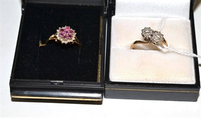 Lot 218 - A diamond two stone twist ring and a ruby and diamond cluster ring
