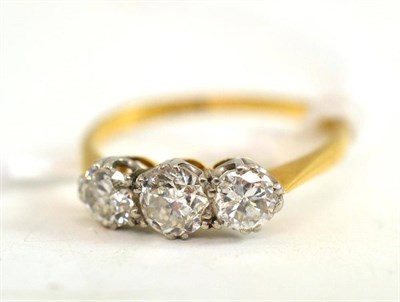 Lot 227 - A diamond three stone ring, the brilliant cut diamonds in white claw settings, to a yellow...