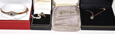 Lot 235 - A 9ct gold emerald and diamond cluster ring, a pendant on chain, pair of earrings and bangle