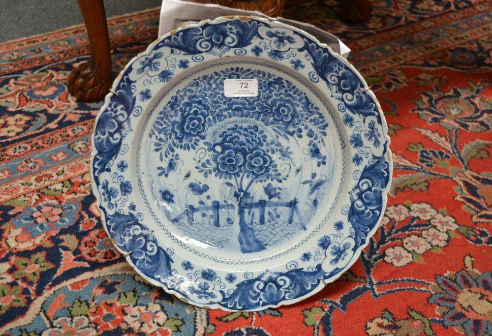 Lot 72 - A Dutch Delft Dish, Fortuyn Factory, late 18th century, painted in blue with tree in a fenced...