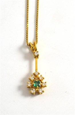 Lot 251 - An 18ct gold emerald and diamond pendant on chain